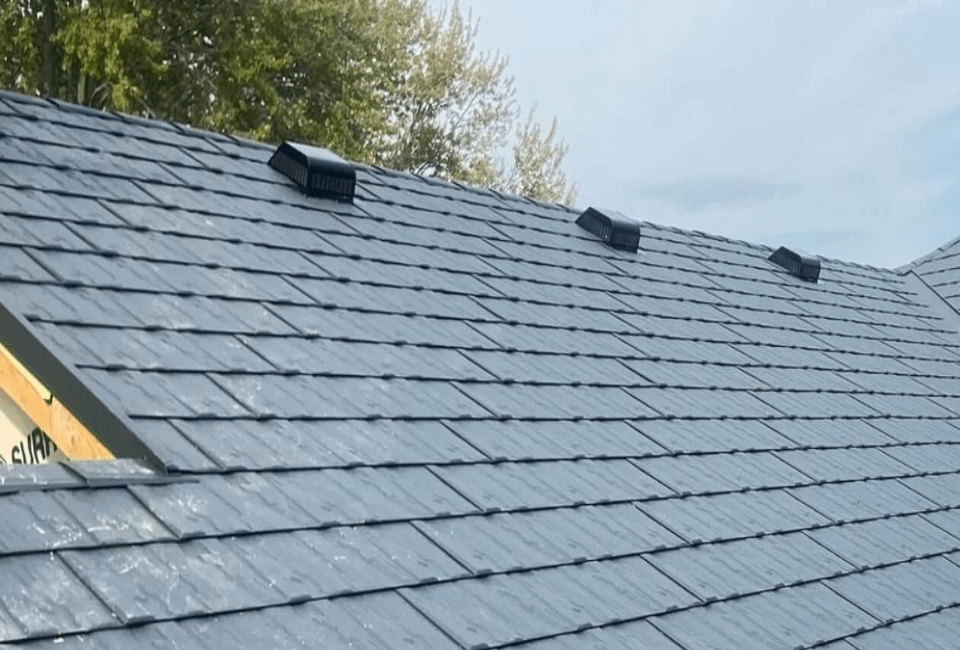 Precision Metal Slate Roof Installation – Westpeak Metal Roofing Crew member securing a metal slate roofing panel during a residential installation.