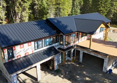 Aerial shot of a home with a newly installed standing seam metal roof in Vernon, BC.