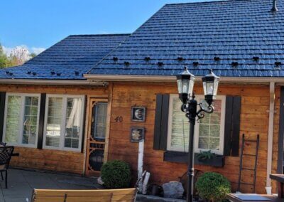 In-progress shot of a metal slate roof installation with panels partially completed.